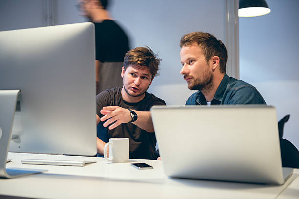 image of men looking at a computer screen